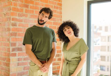 Genç çift el kol hareketi yapıyor. yeni ev kavramı