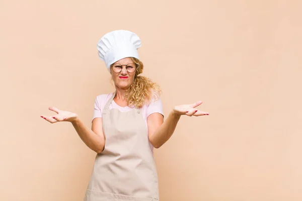 Middle Age Woman Baker Shrugging Dumb Crazy Confused Puzzled Expression — Stok fotoğraf