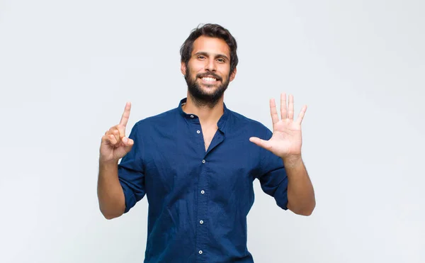 Young Latin Handsome Man Smiling Looking Friendly Showing Number Seven — Stock Photo, Image