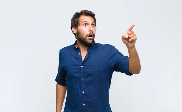 Young Latin Handsome Man Feeling Shocked Surprised Pointing Looking Upwards — Stock Photo, Image