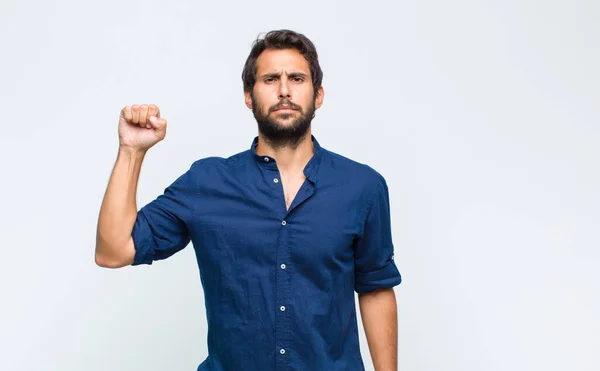 Young Latin Handsome Man Feeling Serious Strong Rebellious Raising Fist — Stock Photo, Image