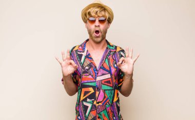 Sarışın, yetişkin, şokta, şaşırmış ve şaşırmış hisseden, onay veren, her iki elinle işaret işareti yapan