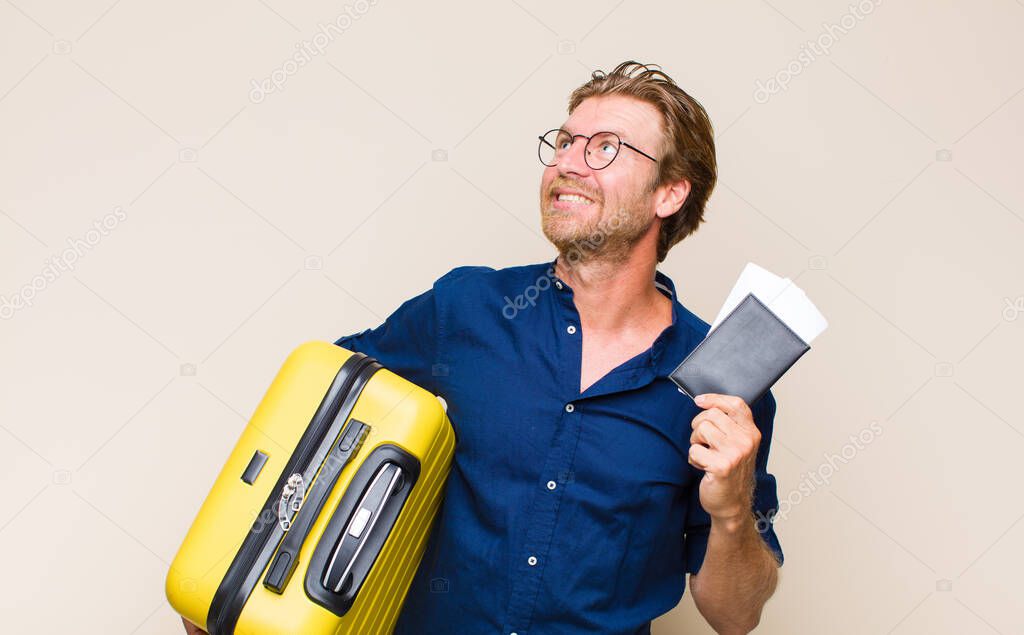 adult blonde man with a case. travel concept.