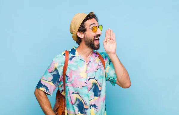 young bearded tourist man profile view, looking happy and excited, shouting and calling to copy space on the side