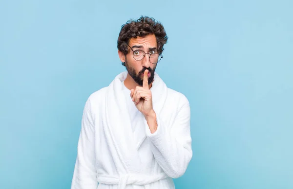 Young Bearded Man Wearing Bath Robe Looking Serious Cross Finger — Stock Photo, Image