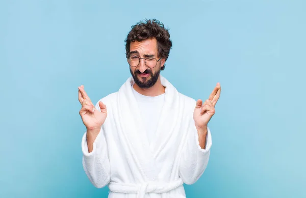 Young Bearded Man Wearing Bath Robe Feeling Nervous Hopeful Crossing — Stock Photo, Image