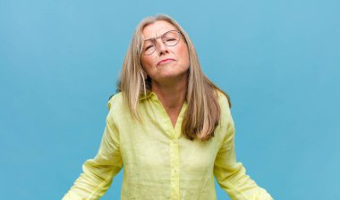 Orta yaşlı, güzel bir kadın heyecanlı ve şaşırmış görünüyor.