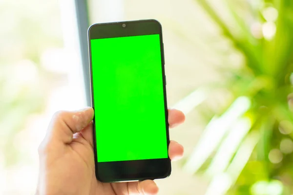 empty green screen smart mobile telephone . chroma key concept