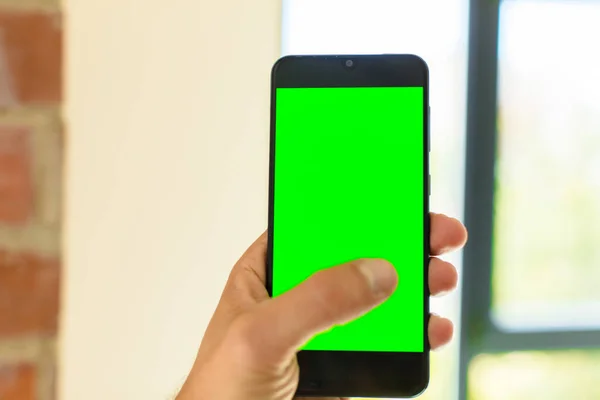 empty green screen smart mobile telephone . chroma key concept