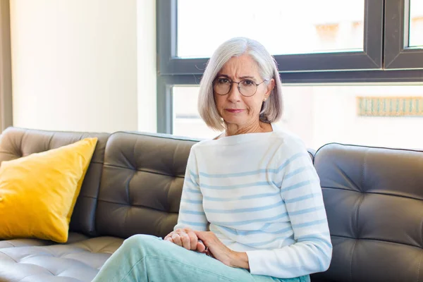 stock image middle age pretty woman feeling sad, upset or angry and looking to the side with a negative attitude, frowning in disagreement