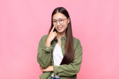 Asyalı genç kadın sana göz kulak oluyor, güvenmiyor, izliyor, tetikte ve tetikte.