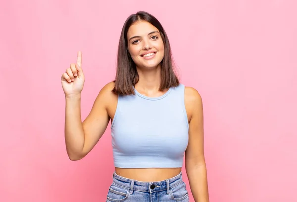 若く美しい女性は陽気で幸せそうです片手で上を向いて空間を写し — ストック写真