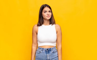 Genç ve güzel bir kadın kafası karışık ve kuşkulu, merak ediyor ya da karar vermeye çalışıyor.