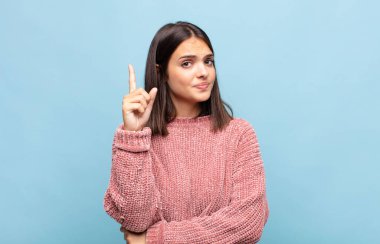 Genç ve güzel bir kadın, harika bir fikri fark ettikten sonra parmağını havaya kaldırıp 