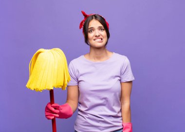 Genç, güzel bir kadın kafası karışmış ve kafası karışmış görünüyor. Sinirli bir hareketle dudağını ısırıyor. Sorunun cevabını bilmiyor.