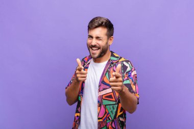 Genç adam kendini mutlu, sakin, tatmin olmuş, rahat ve başarılı hissediyor, kameraya bakıyor, seni seçiyor.