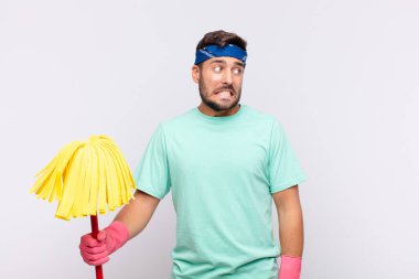 Genç adam endişeli, stresli, endişeli ve korkmuş görünüyor, panikliyor ve dişlerini sıkıyor.