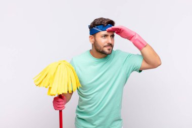 Genç adam şaşkınlık ve şaşkınlık içinde bakıyor, uzaktan bakıyor, izliyor ya da arıyor.