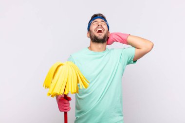 Genç adam gülümsüyor ve rahatlıyor, tatmin oluyor, kaygısız, neşeli ve rahatlatıcı.