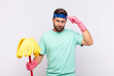 Ciddi ve yoğun bakışlı genç bir adam, beyin fırtınası yapıyor ve zorlu bir sorunu düşünüyor.