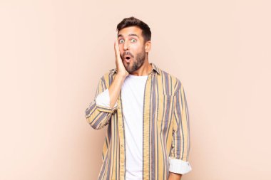 Delikanlı ağzı açık bir şekilde yüz yüze inanmayarak şok olmuş ve hayrete düşmüş hissediyor.