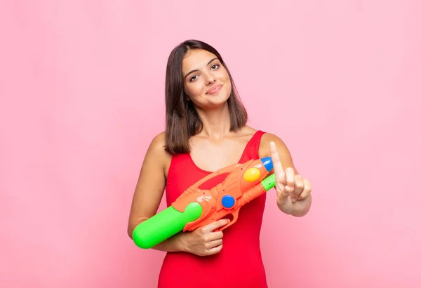 Young Pretty Woman Smiling Looking Friendly Showing Number One First — Stock Photo, Image