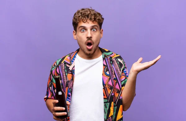 Young Man Looking Surprised Shocked Jaw Dropped Holding Object Open — Stock Photo, Image