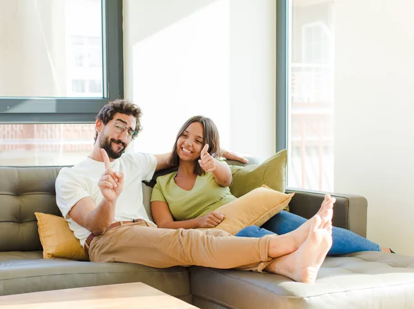 Young Couple Smiling Proudly Confidently Making Number One Pose Triumphantly — Stock Photo, Image