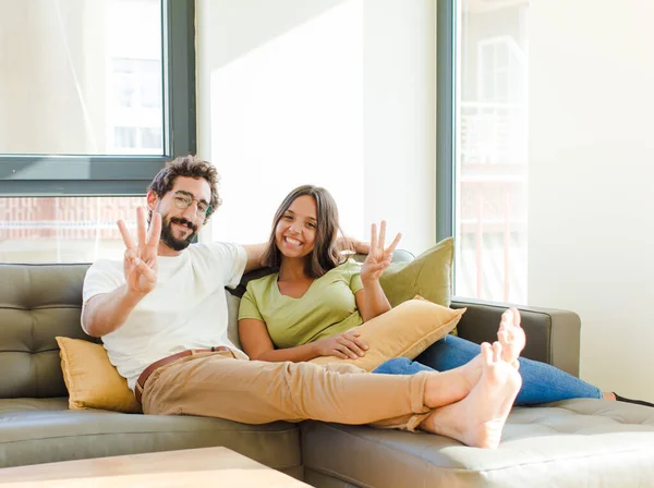 Young Couple Smiling Looking Friendly Showing Number One First Hand — Stock Photo, Image