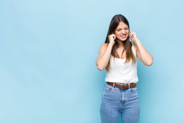 Sen güzel bir kadın kızgın, stresli ve sinirli görünüyor, iki kulağı da sağır edici bir gürültü, ses ya da yüksek sesle kapatıyor