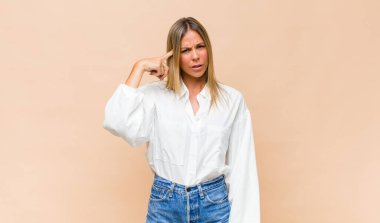 Genç, güzel bir kadın kafası karışık ve şaşkın hissediyor. Deli, deli ya da aklını kaçırmış olduğunu gösteriyor.