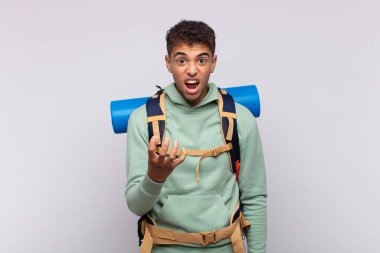 young man looking angry, annoyed and frustrated screaming wtf or whats wrong with you. soccer concept 