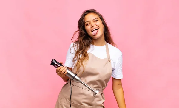 Young Woman Baker Cheerful Carefree Rebellious Attitude Joking Sticking Tongue — Zdjęcie stockowe