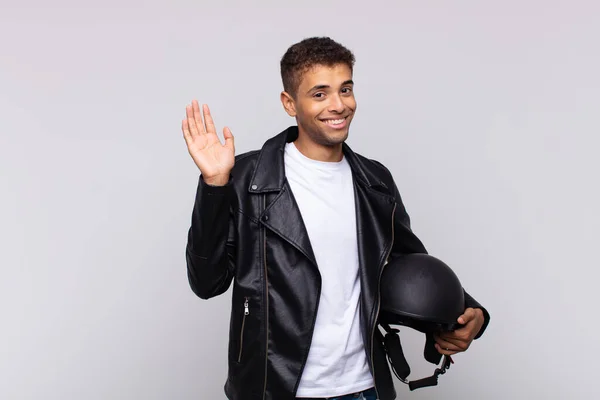 Young Motorbike Rider Smiling Happily Cheerfully Waving Hand Welcoming Greeting — Foto Stock