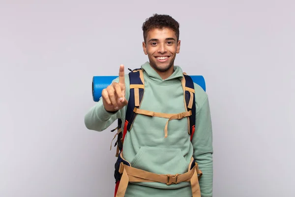 Young Hiker Man Smiling Looking Friendly Showing Number One First — Fotografia de Stock