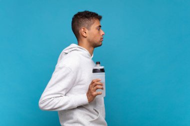 young man on profile view looking to copy space ahead, thinking, imagining or daydreaming. sport concept