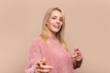 Kadın kendini mutlu, havalı, tatmin olmuş, rahat ve başarılı hissediyor, kameraya bakıyor, seni seçiyor.