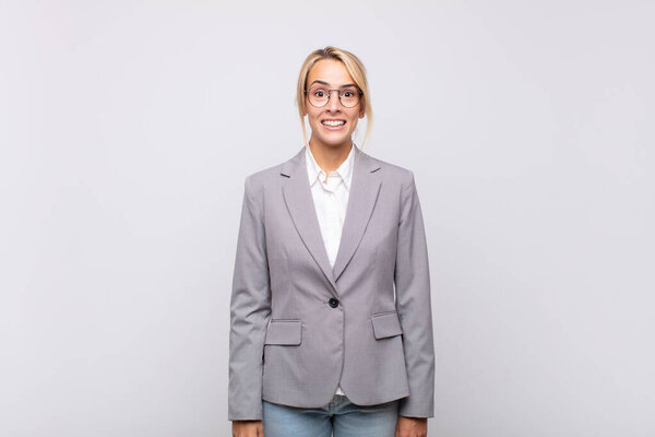 young businesswoman looking happy and pleasantly surprised, excited with a fascinated and shocked expression