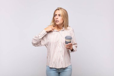 young woman with a coffee feeling stressed, anxious, tired and frustrated, pulling shirt neck, looking frustrated with problem