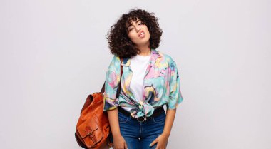 Woman feeling puzzled and confused, with a dumb, stunned expression looking at something unexpected