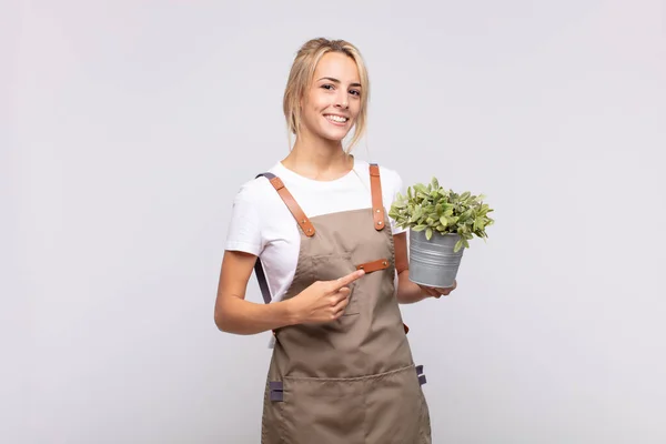 Giovane Donna Giardiniere Sorridente Allegramente Sensazione Felice Indicando Lato Verso — Foto Stock