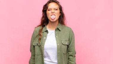 Kadın kendini iğrenç ve rahatsız hissediyor, dilini dışarı çıkarıyor, iğrenç ve iğrenç bir şeyden hoşlanmıyor.