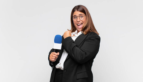 молодая женщина-репортер чувствует себя счастливой, позитивной и успешной, мотивированной перед вызовом или празднуя хорошие результаты