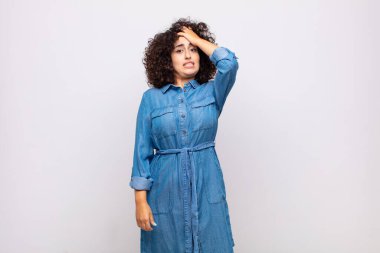 Woman raising palm to forehead thinking oops, after making a stupid mistake or remembering, feeling dumb