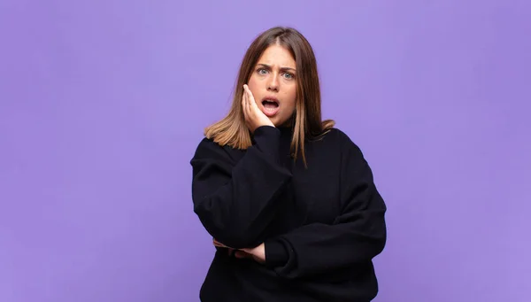 Young Blonde Woman Open Mouthed Shock Disbelief Hand Cheek Arm — Stock Photo, Image