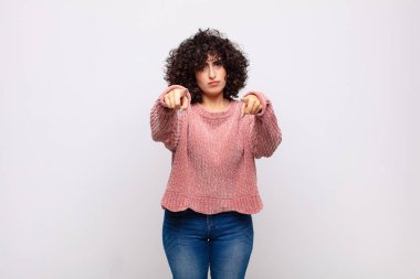 Kameraya doğru bakan bir kadın iki parmağıyla ve kızgın bir ifadeyle sana görevini yapmanı söylüyor.