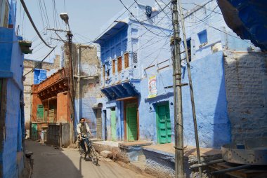Jodhpur, Hindistan - 06 Nisan 2007: Tanımlanamayan genç adam sürmek bisiklet tarafından dar sokağın Jodhpur, Hindistan.