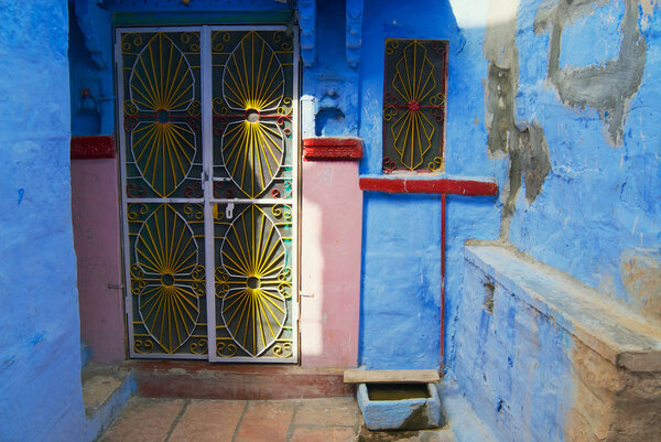 Jodhpur, India - April 04, 2007: Metal door at the old traditional blue painted house in Jodhpur, India.