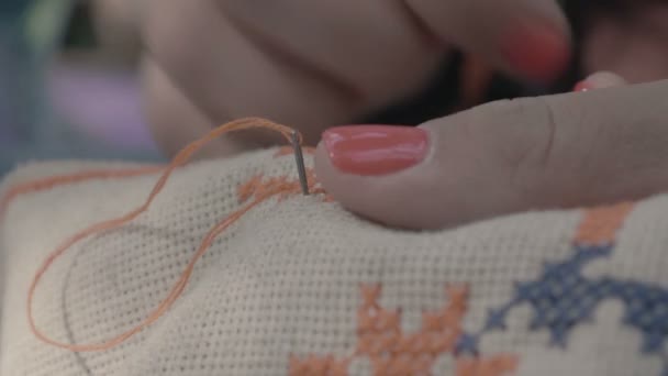 Close up shot of the Fingers embroidered girl cross. — Stock Video