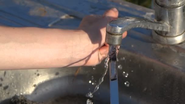 Female hands rubbing a long skewer with a wisp outdoors in slow motion — Stock Video